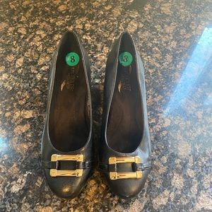 Black pumps with gold buckle